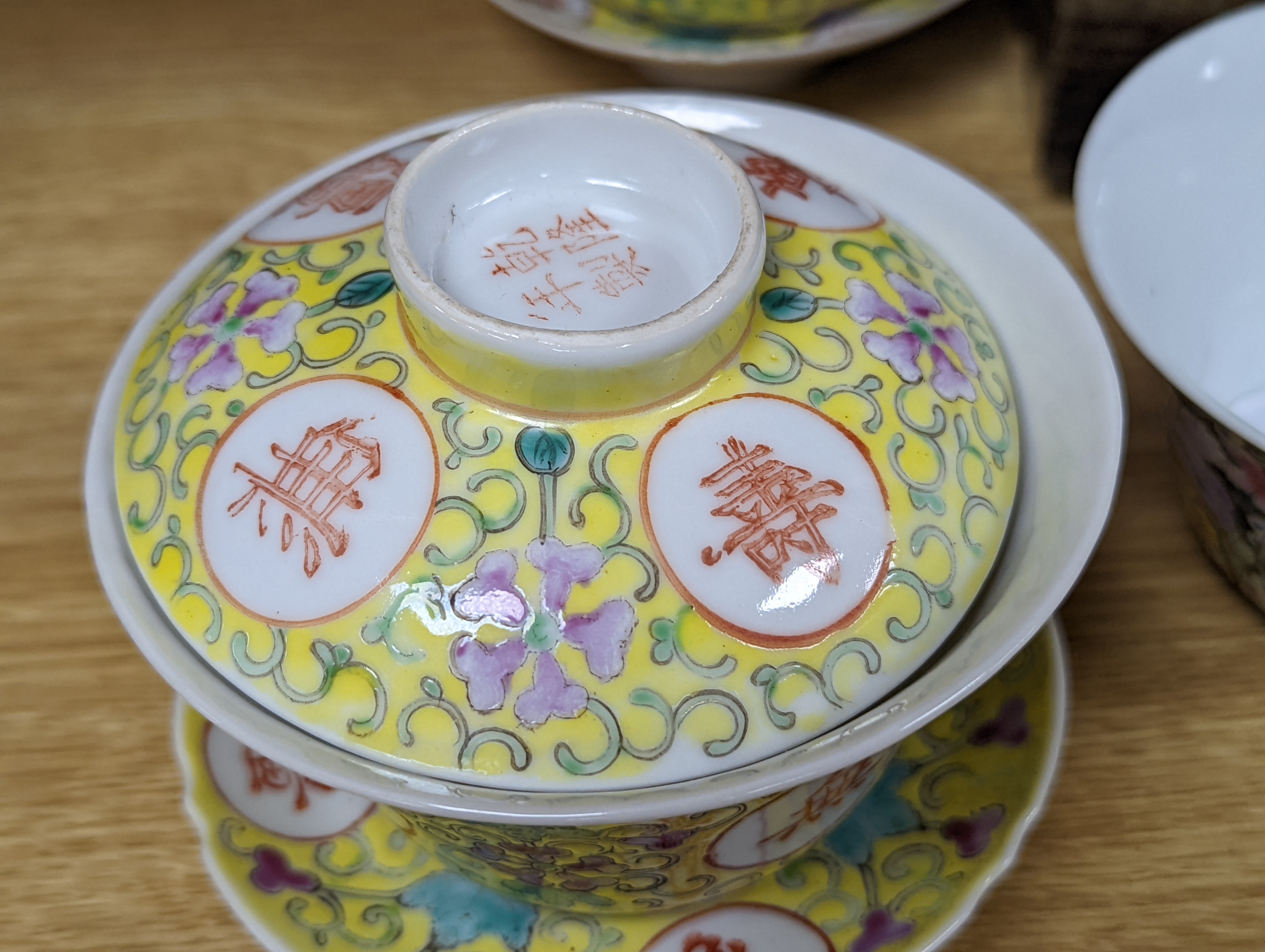 A pair of Chinese enamelled porcelain rice bowls, covers and stands and an odd bowl